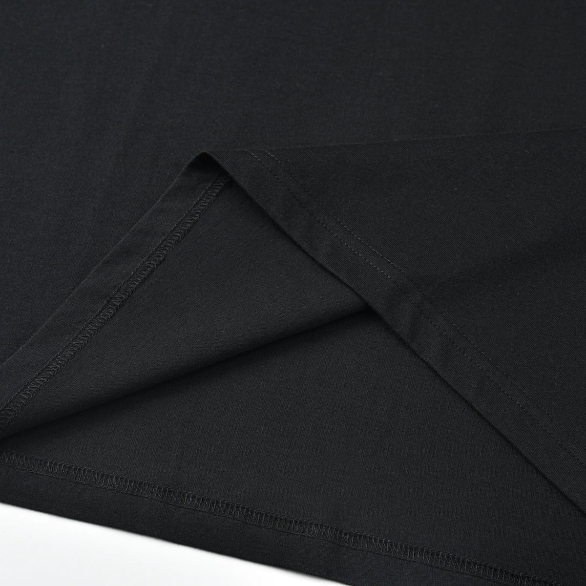 Close-up of the black Pagulayan PAGS Shirt inner hem and stitching construction.