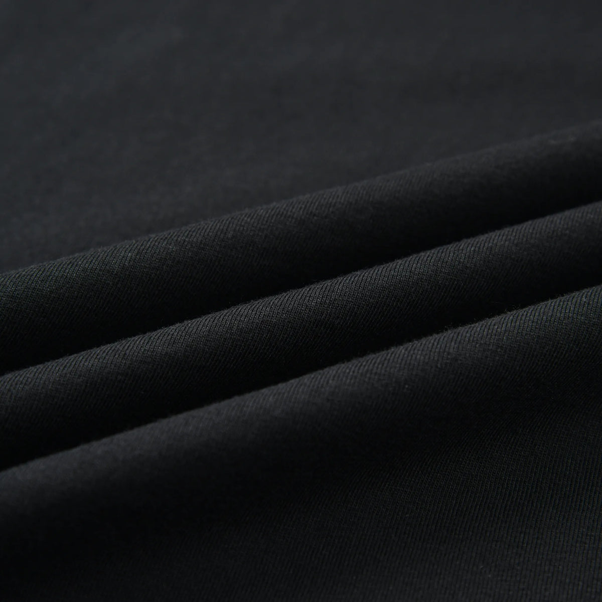 Close-up of the black fabric texture of the Stealth Pagulayan Logo Long Sleeve Shirt.