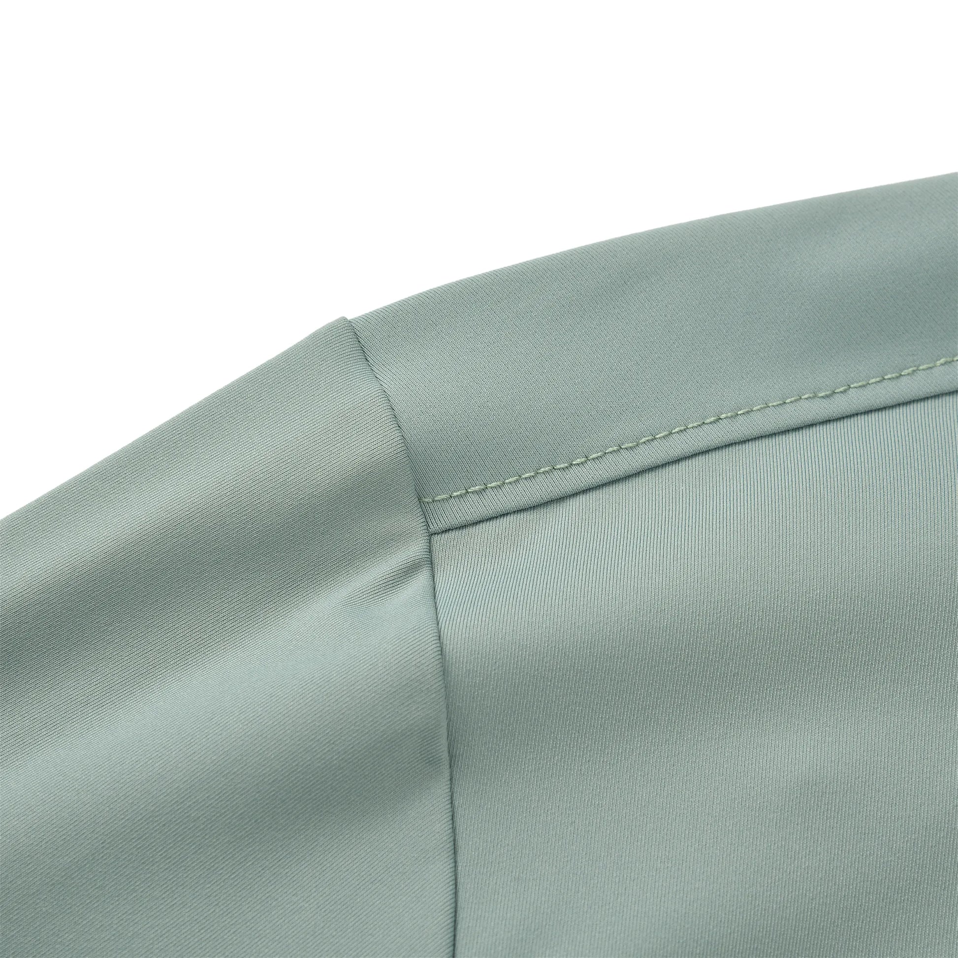 The image shows the stitched shoulder seam of the Team Ontario billiards jersey in light sage green fabric.