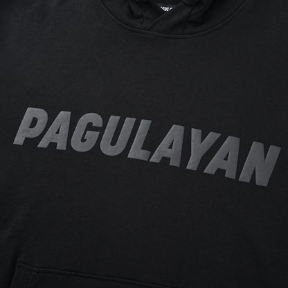 Close-up of the Blackout Hoodie chest showing the matte black Pagulayan logo across the front.