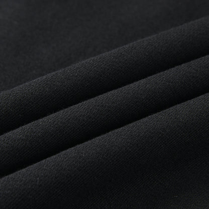 Close-up of the Blackout Hoodie fabric showing the soft, smooth black knit material.