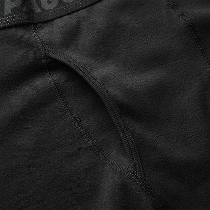 Close-up of black 100% cotton boxer briefs showing soft fabric texture and reinforced stitching for comfort.
