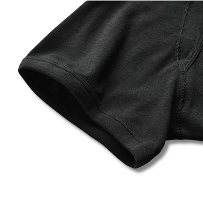 Close-up of black 100% cotton boxer briefs showing smooth leg opening and soft fabric for everyday comfort.