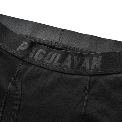 Close-up of black 100% cotton boxer briefs waistband with Pagulayan Cues branding and soft elastic fit.