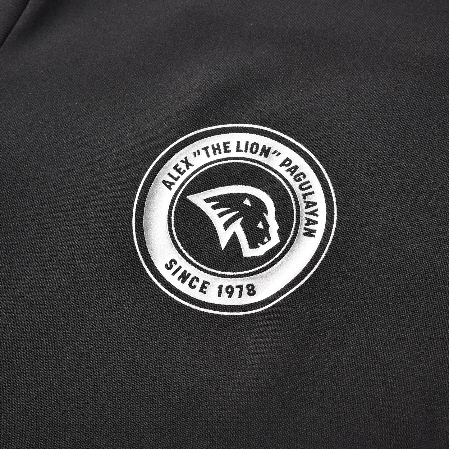 Close-up of the Pagulayan circular chest logo featuring the lion emblem and the text “Alex ‘The Lion’ Pagulayan Since 1978.”