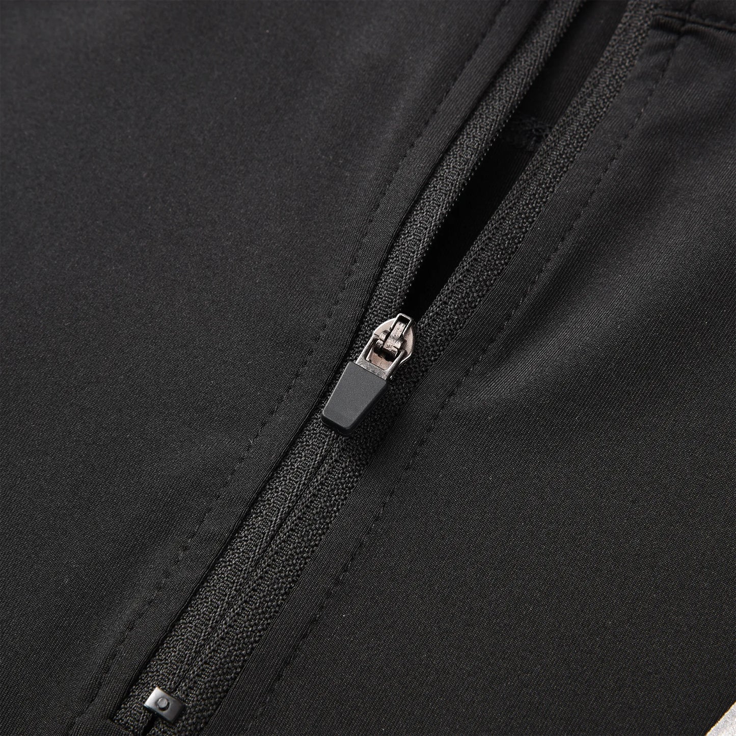 Close-up view of the Pagulayan Jersey zipper showing the smooth black fabric and durable zip design.