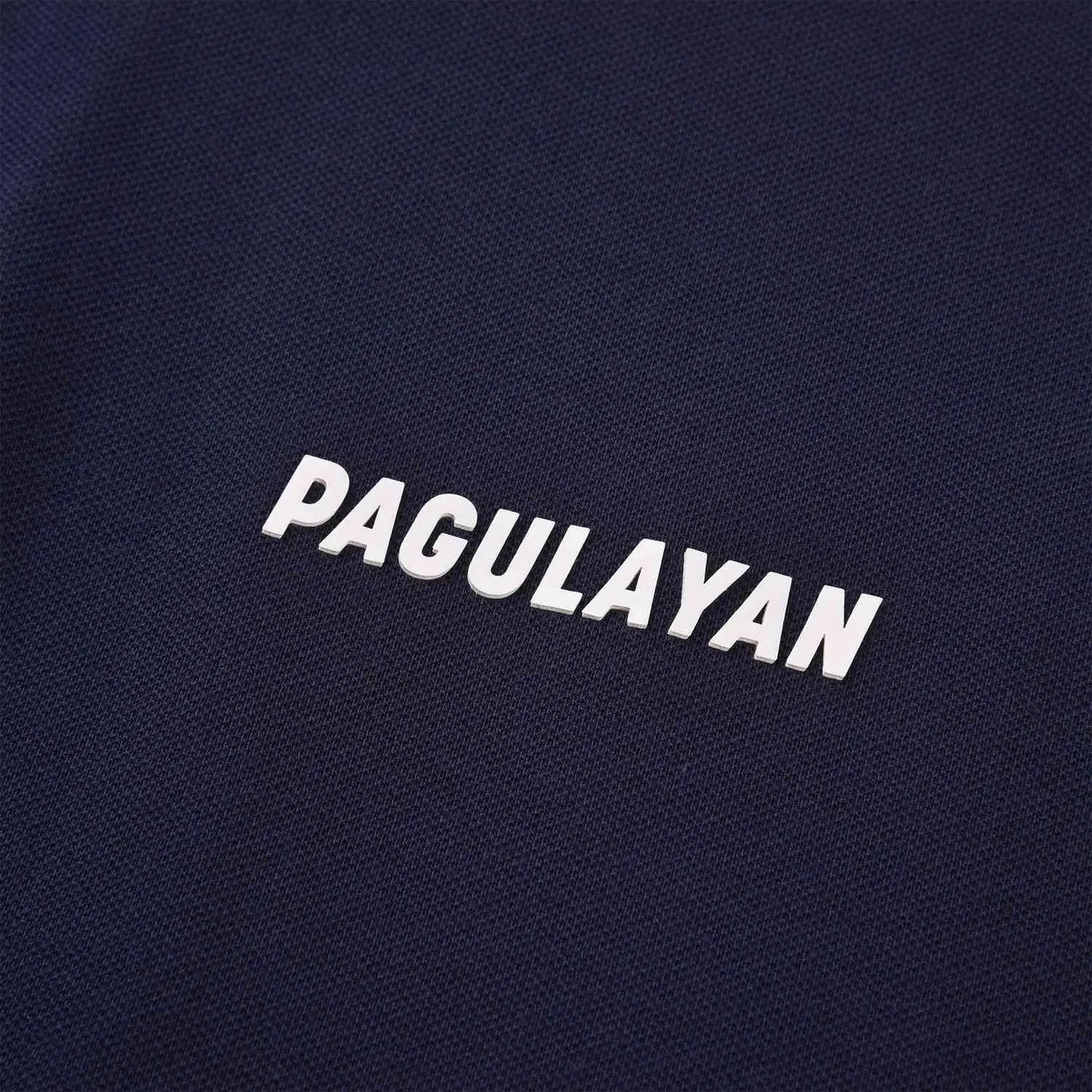 Close-up of raised Pagulayan logo on navy cotton pique polo shirt, premium breathable billiards polo apparel.