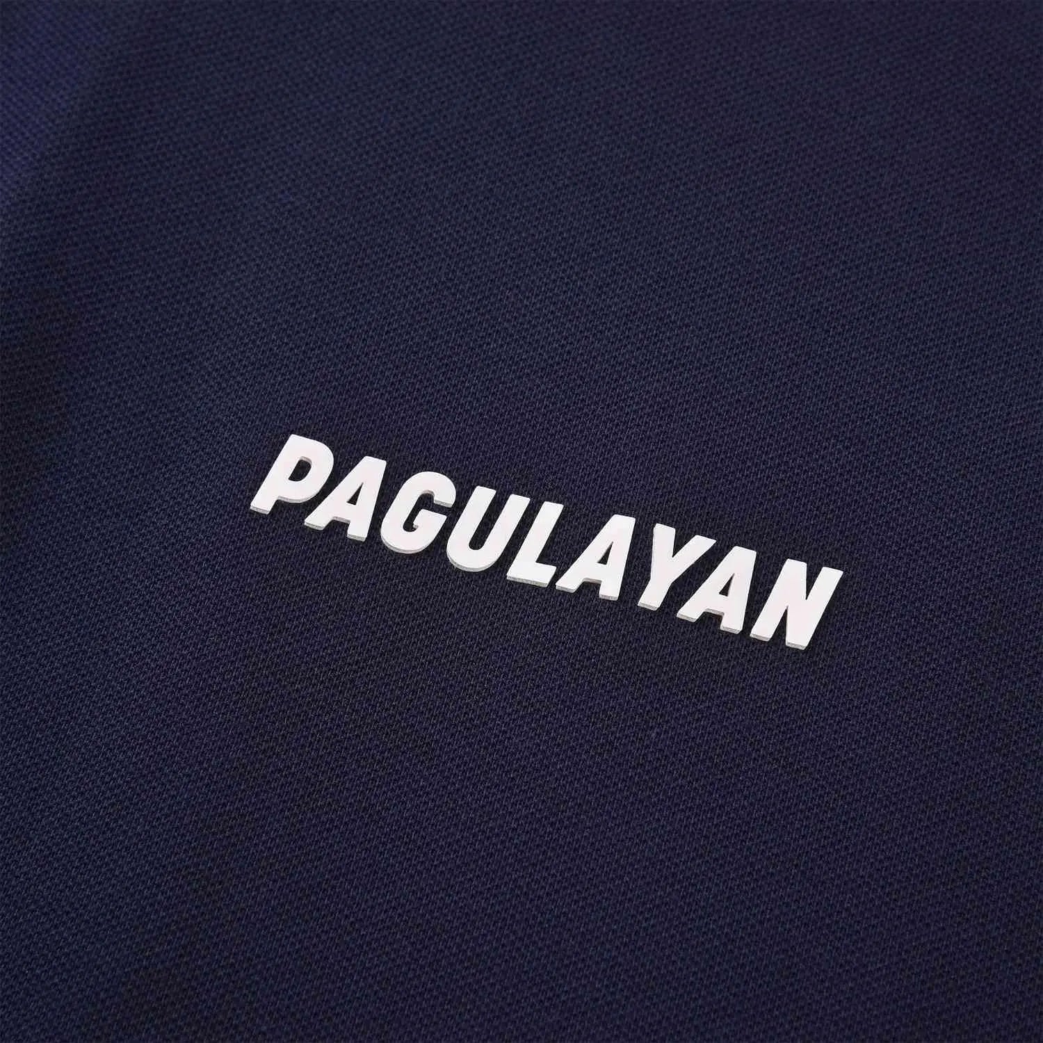 Close-up of raised Pagulayan logo on navy cotton pique polo shirt, premium breathable billiards polo apparel.