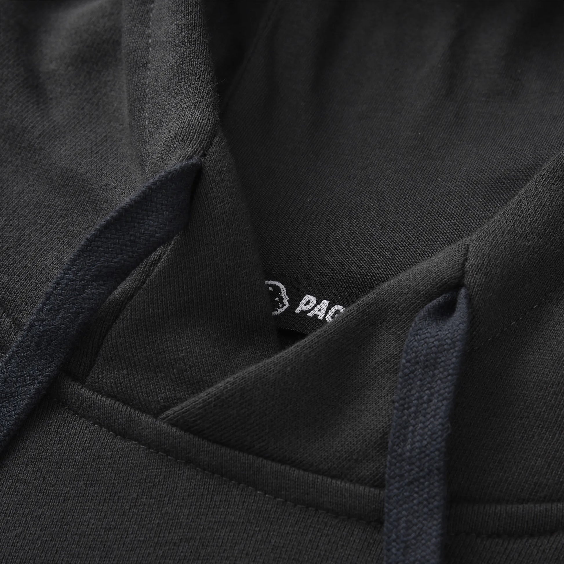 Close up of the Pagulayan Men’s Pocket Hoodie showing the hood stitching, drawstrings, and inner label detail.