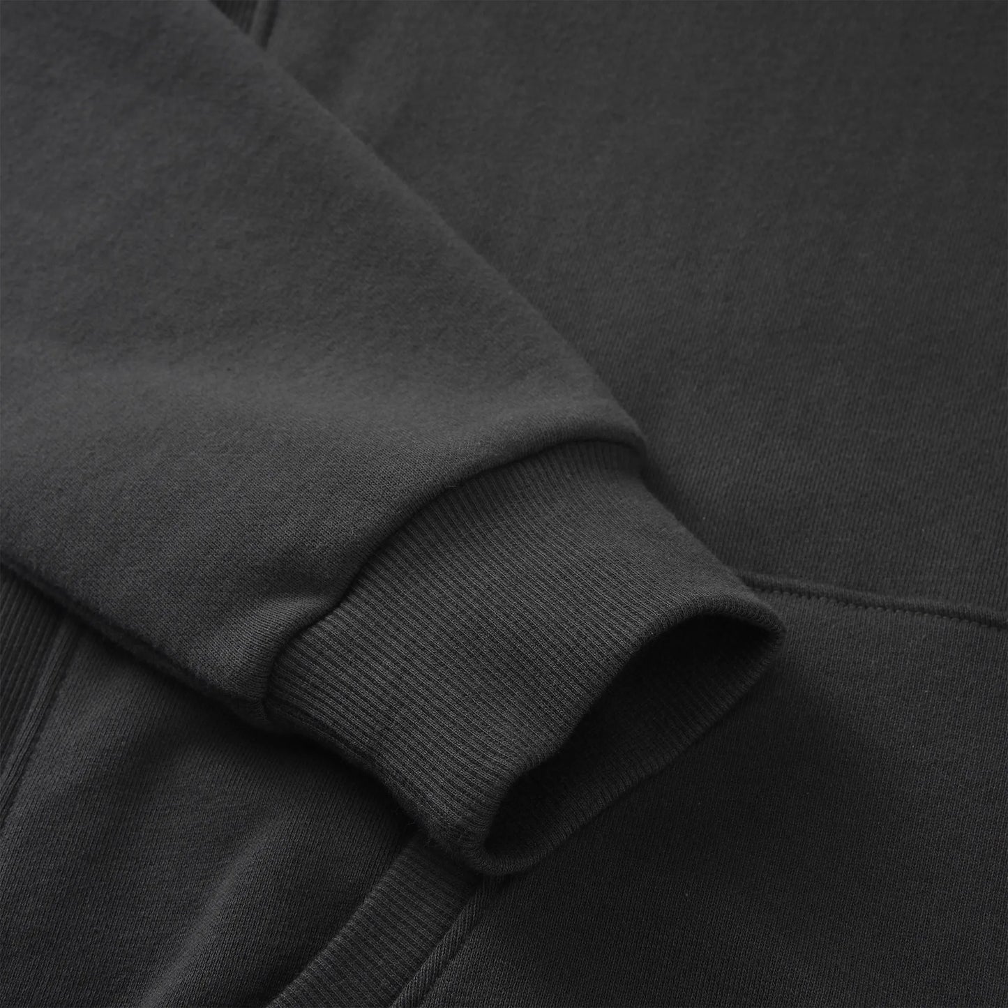 Close up of the Pagulayan Men’s Pocket Hoodie sleeve showing the ribbed cuff and smooth fabric texture.