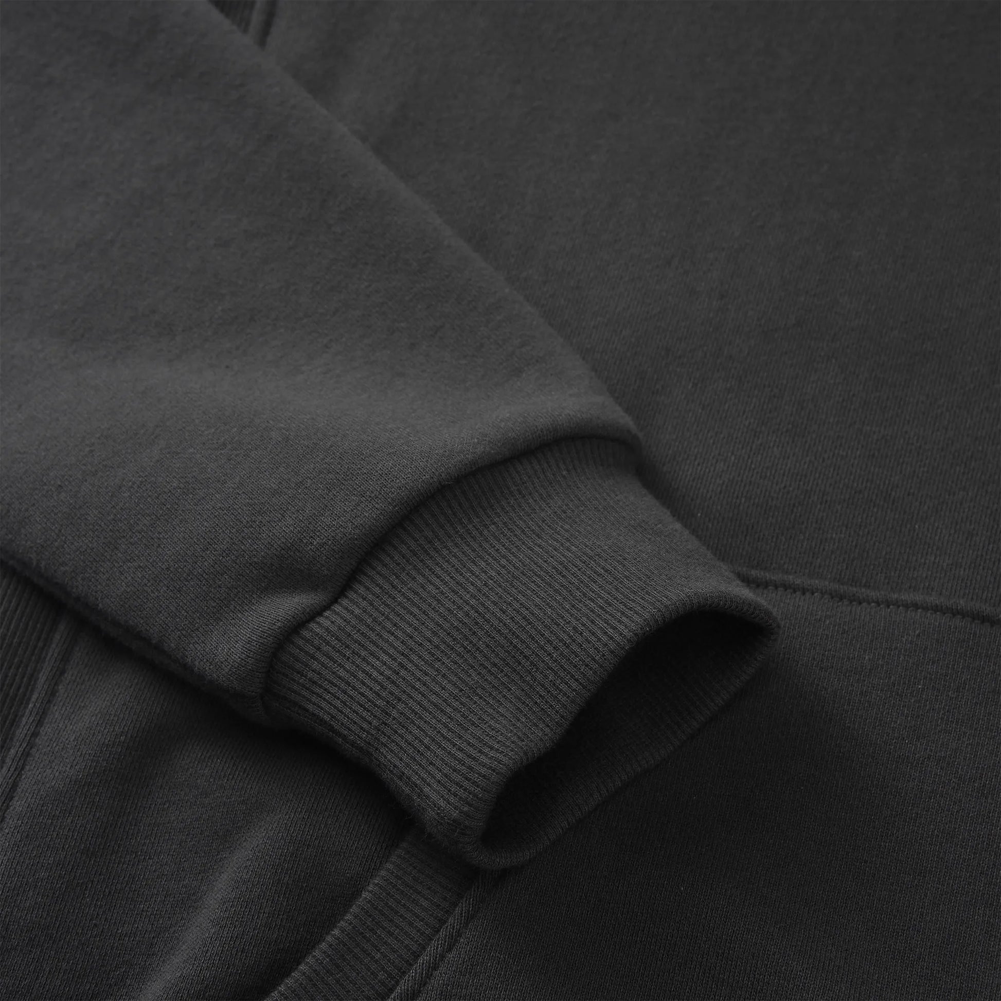 Close up of the Pagulayan Men’s Pocket Hoodie sleeve showing the ribbed cuff and smooth fabric texture.