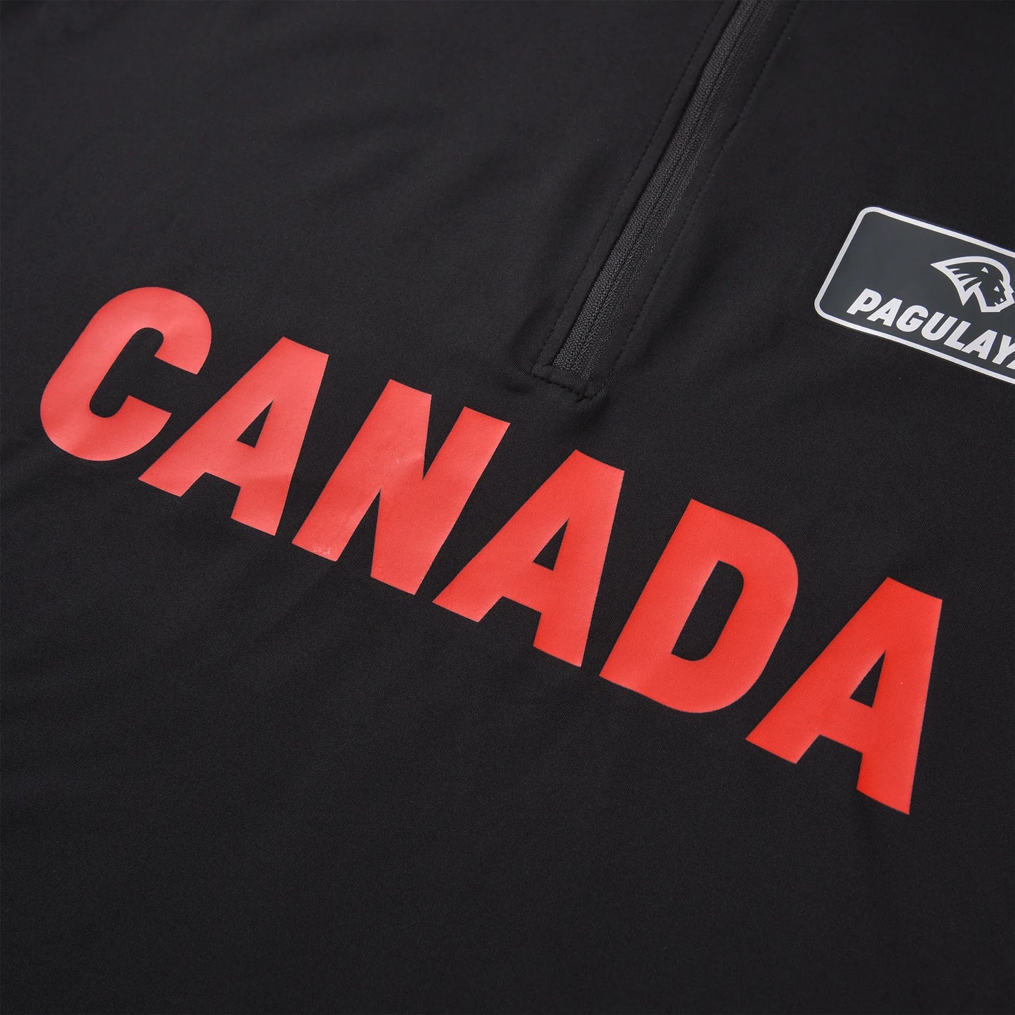 Close-up of the CANADA front print and zipper area on the Pagulayan Men’s Team Canada billiards jersey.