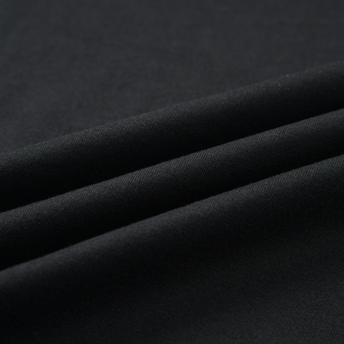 Close-up of the black fabric texture and material of the Pagulayan PAGS Shirt.