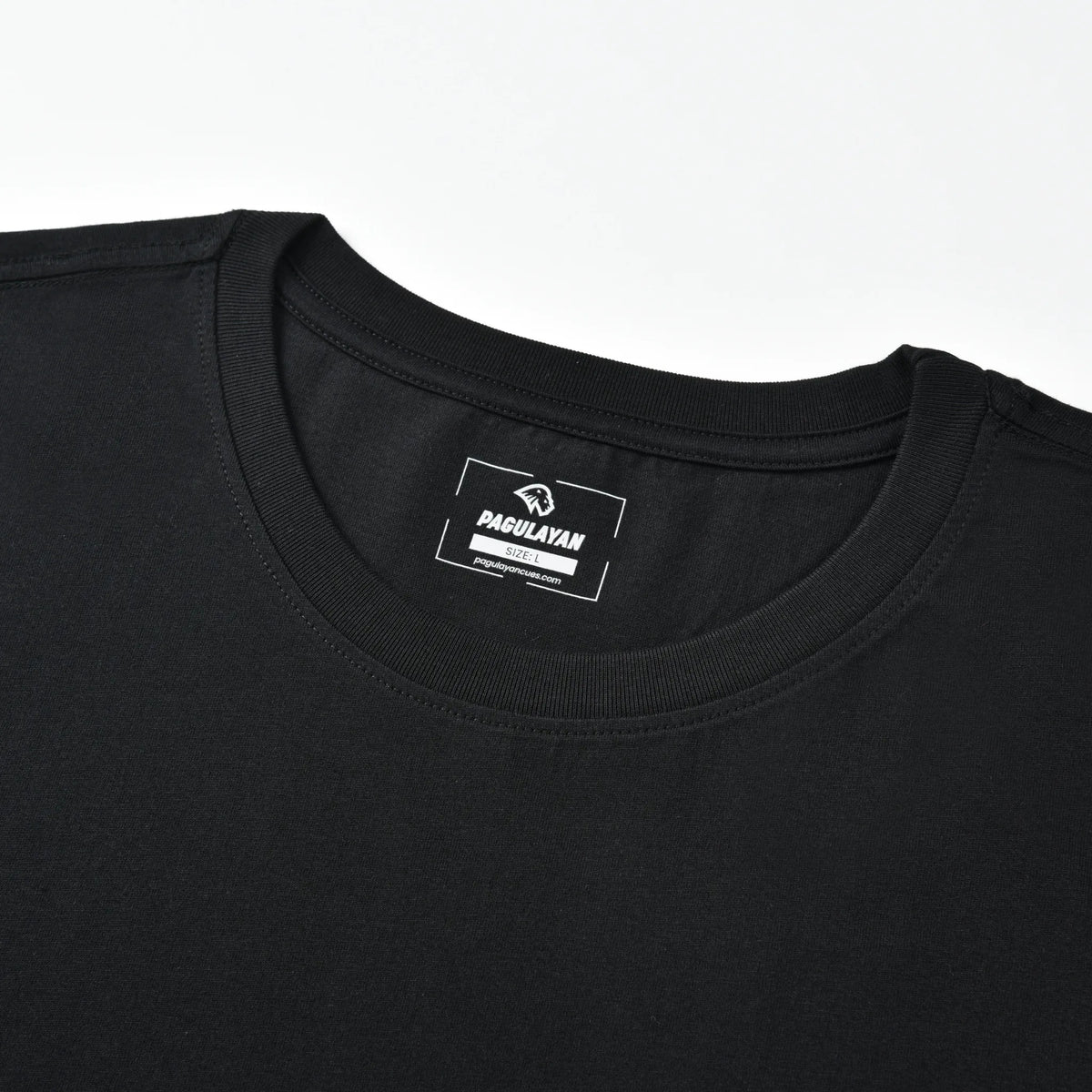 Close-up of the black PAGS Shirt crew neck collar with printed Pagulayan label.