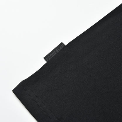 Close-up of the Pagulayan side tag and hem detail on the black PAGS Shirt.