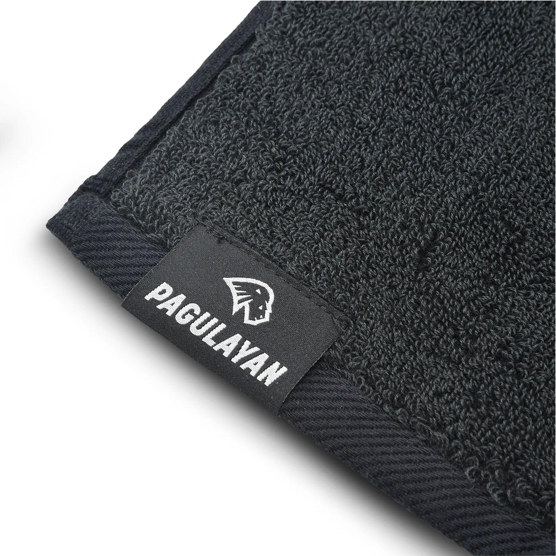 Close-up of the Pagulayan logo label stitched onto a 100% cotton pool cue towel with textured surface.