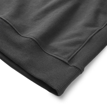 Close up of the Pagulayan Puff Logo Hoodie hem showing the ribbed edge and smooth fabric texture.