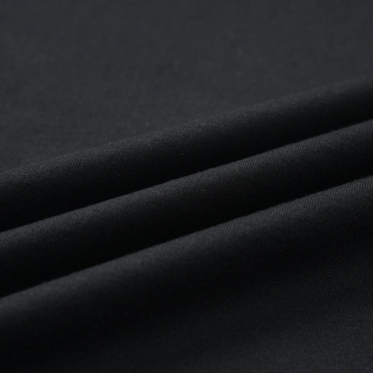 Close-up of the black fabric texture and material of the Small Pagulayan Logo Shirt.