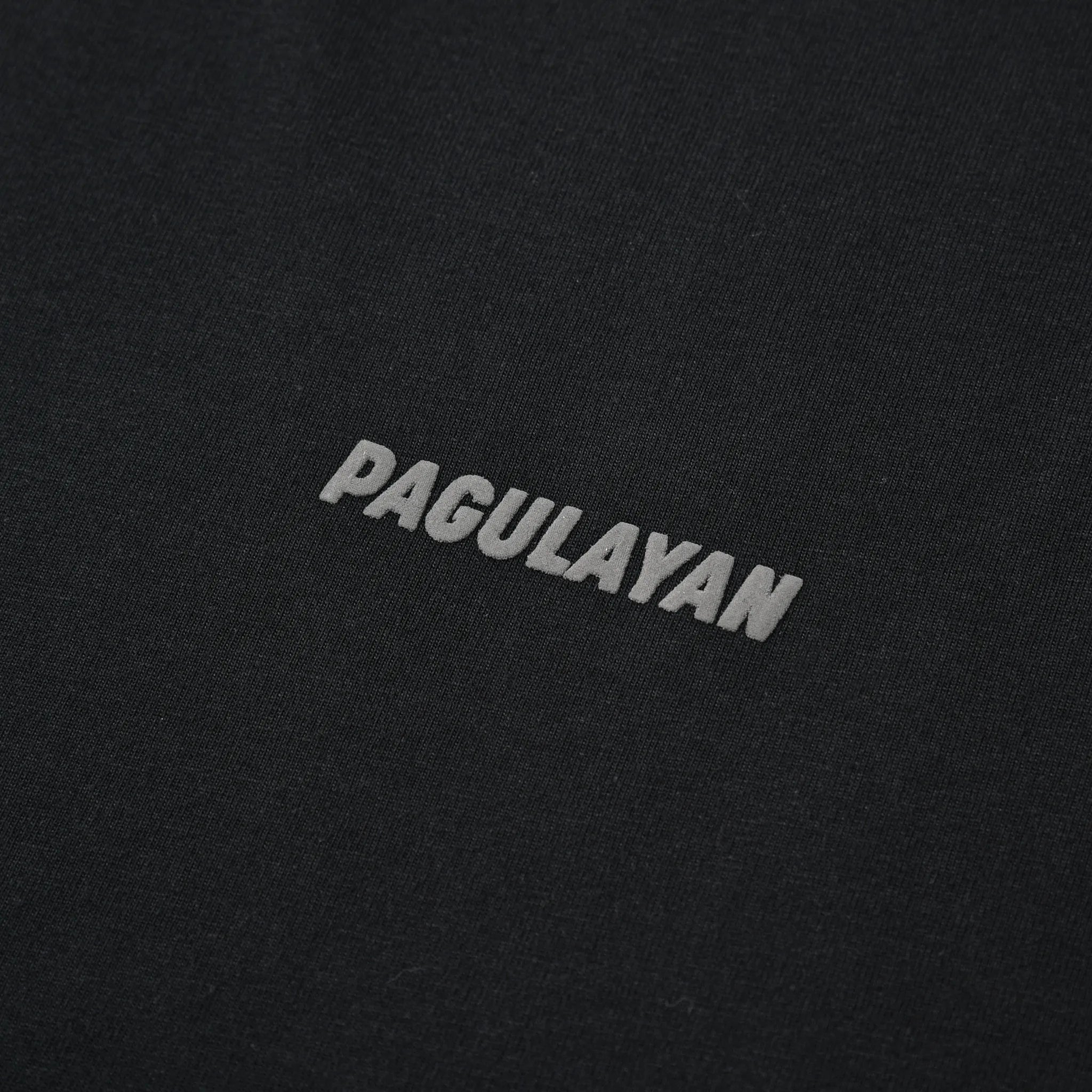 Close-up of the small Pagulayan chest logo on the black Small Pagulayan Logo Shirt.