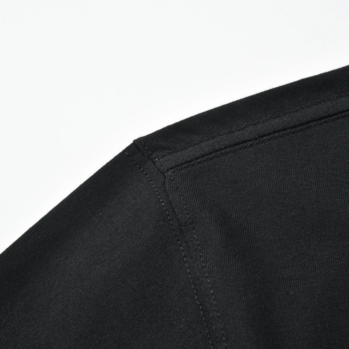 Close-up of the black Small Pagulayan Logo Shirt shoulder seam and stitching.