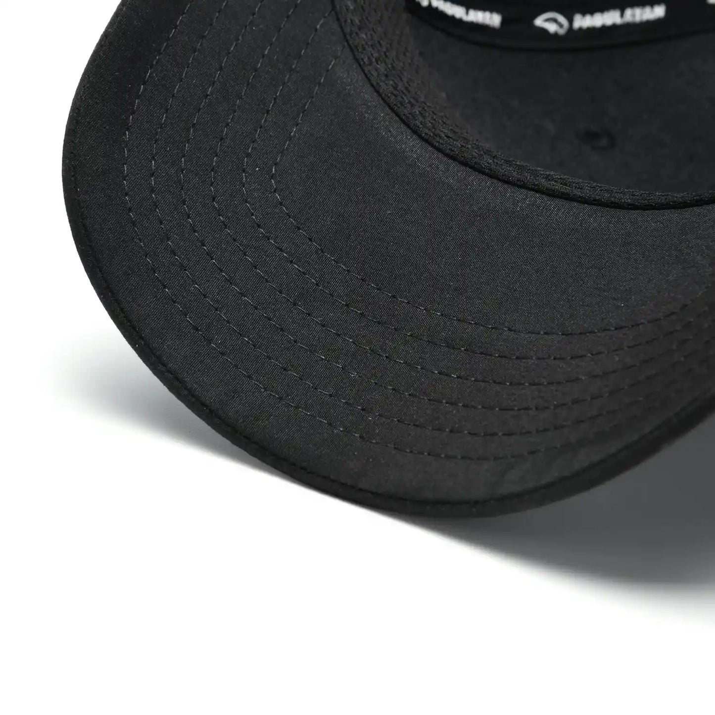 Close-up of Pagulayan Stealth Logo black snapback cap curved brim showing stitched bill detail.