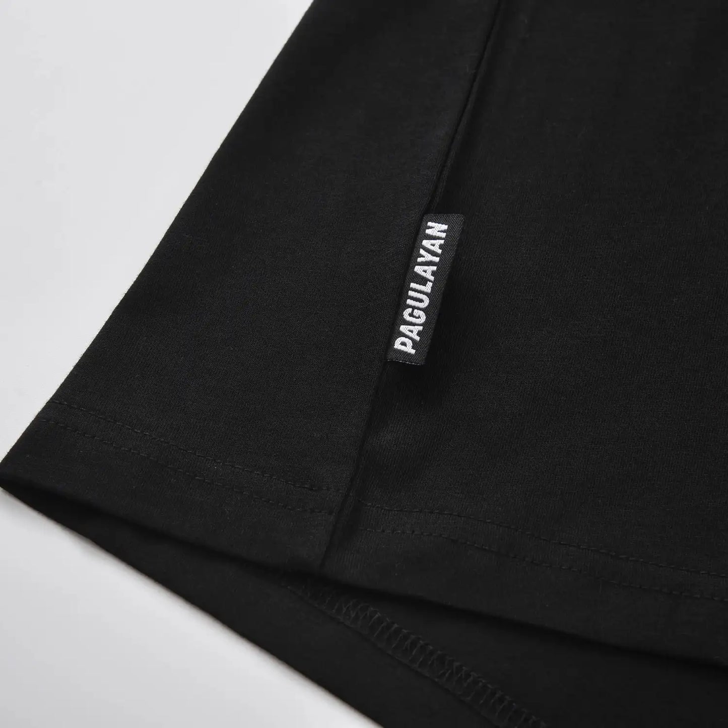 Pagulayan brand tag detail on The Subtle T-Shirt minimalist black cotton t shirt.