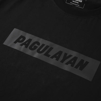 Close-up of minimalist Pagulayan logo on The Subtle T-Shirt black cotton t-shirt.