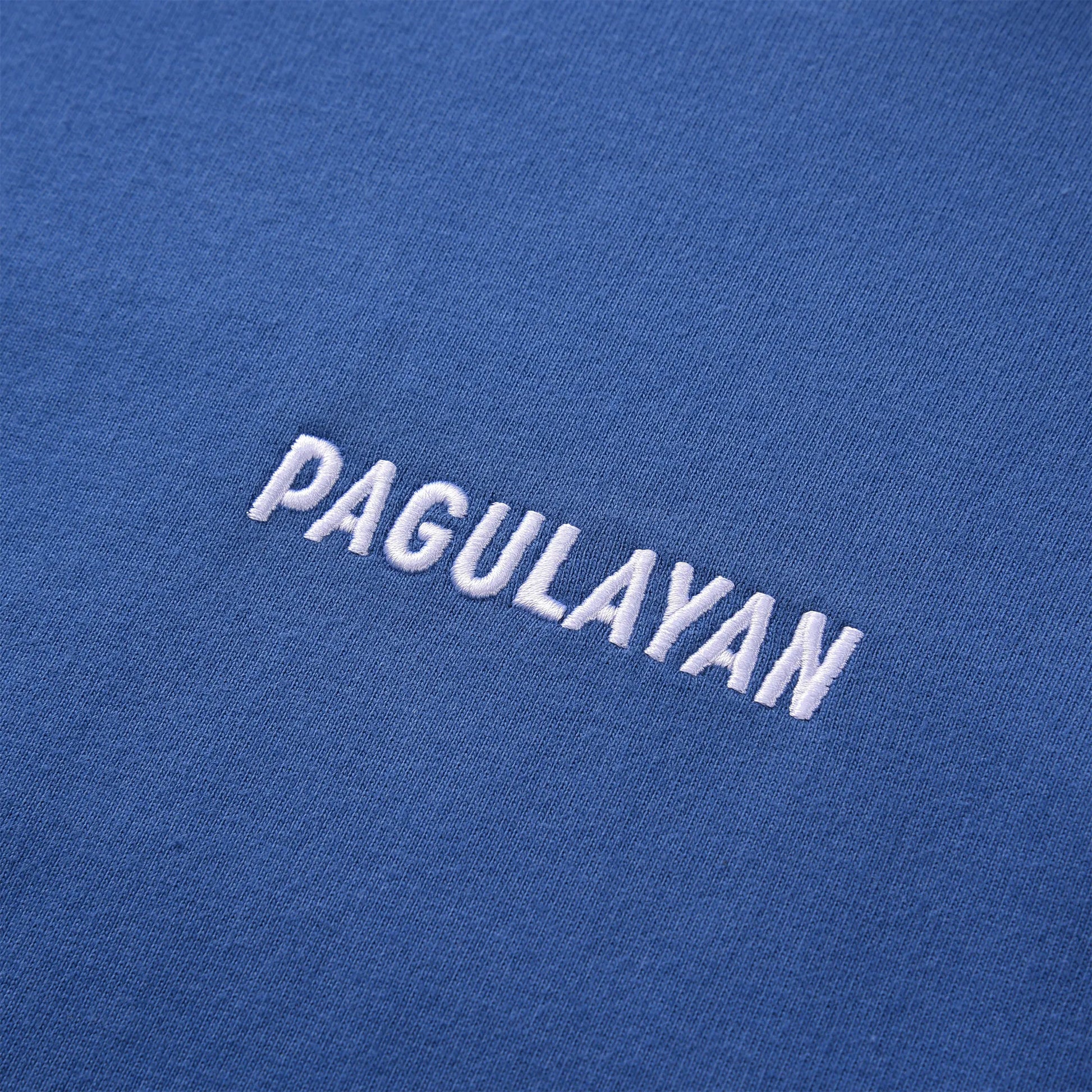 Close up of the Pagulayan Women’s Drop-Shoulder Pocket Hoodie chest logo showing the white embroidered lettering.