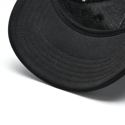 Close-up of Pagulayan black trucker cap curved bill with stitched detailing on the front brim.