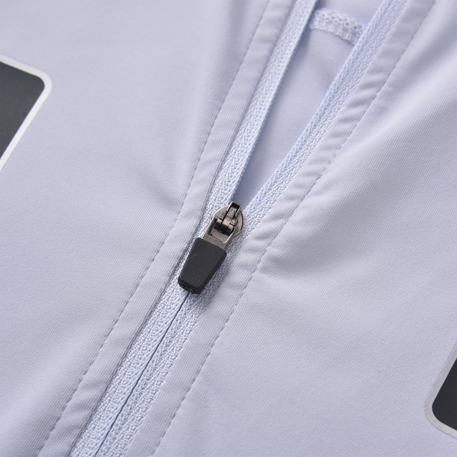 A detailed close-up of the zipper on the Pagulayan Quebec billiards jersey showing the white fabric and precise stitching.