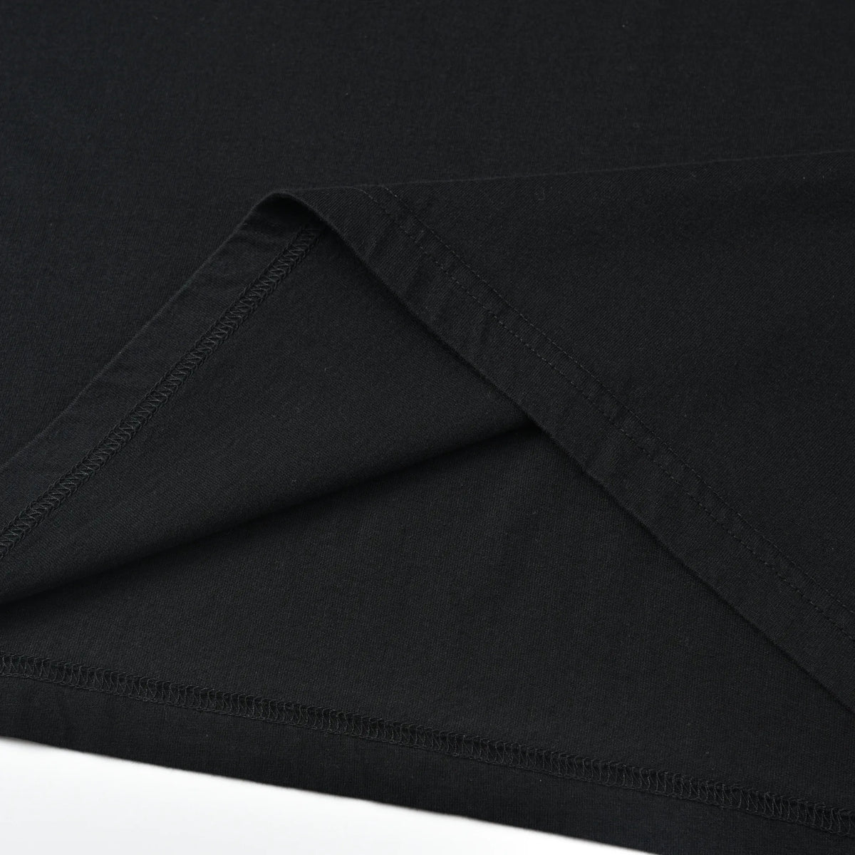 Close-up of the bottom hem and interior stitching on the Stealth Pagulayan Logo Long Sleeve Shirt.