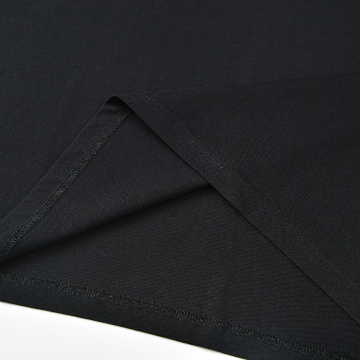 Close-up of the inner hem and stitching on the black Stripe Pagulayan Logo Shirt.