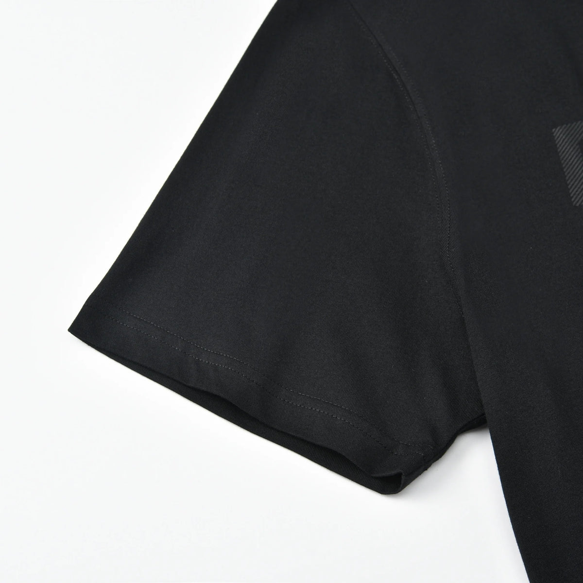 Close-up of the short sleeve and hem stitching on the black Stripe Pagulayan Logo Shirt.