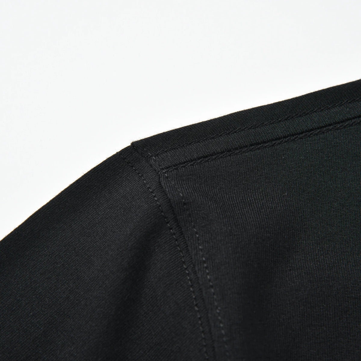 Close-up of the shoulder seam and stitching on the black Stripe Pagulayan Logo Shirt.